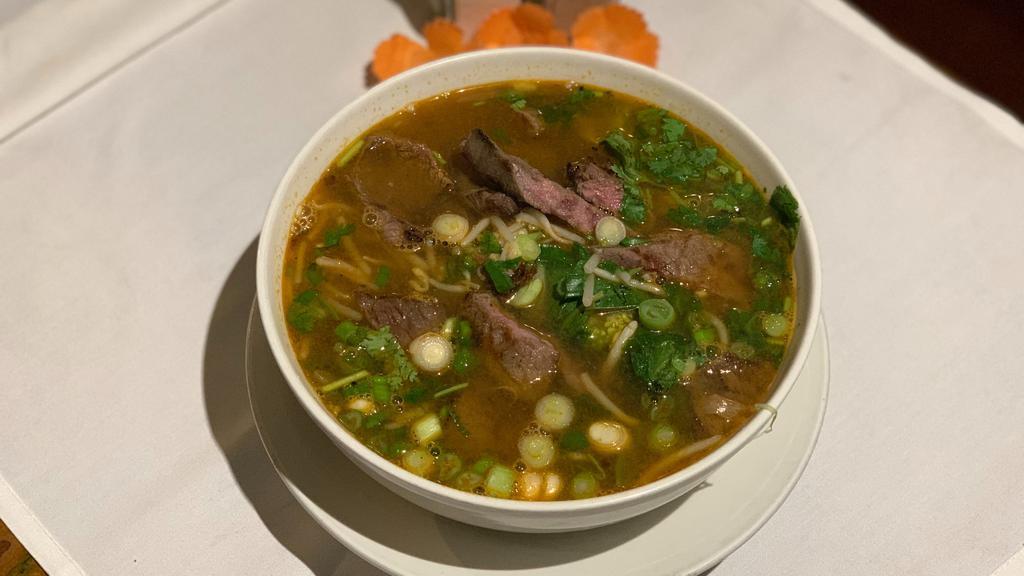 Grilled Beef Pho · Fettuccine rice noodle soup with sliced beef, snow pea, onion, broccoli, carrot cilantro, basil, scallion and bean sprout in richly seasoned beef broth.