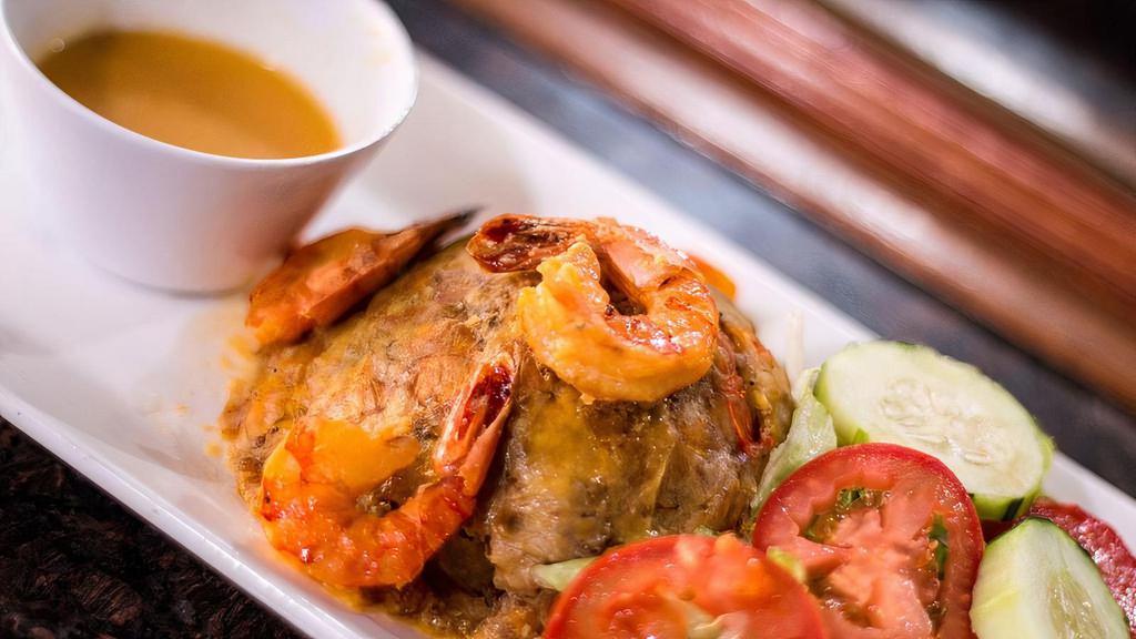 Shrimp Mofongo · Fried mashed garlic green plantains.
in a ball stuffed with garlic shrimp. 
garlic shrimp  side and shrimp sauce smothered.