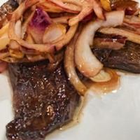 Skirt Steak · Flame grilled Skirt Steak topped with onions and seasonings.
Served with rice and beans/gree...