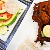 Breaded Steak · marinated and then breaded deep-fried steak.
Served with rice and beans/ green or sweet plan...