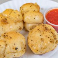 Garlic Knots (4 Pc) · Fresh out of the oven, warm and garlicy bread bites.