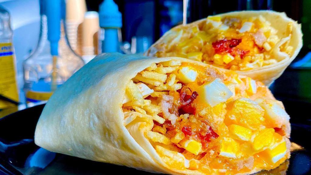 The M.F.B.A. · A breakfast burrito like no other! Two eggs diced with your choice of bacon or sausage, shredded cheddar cheese, crisp julienned potato, and creamy hot sauce