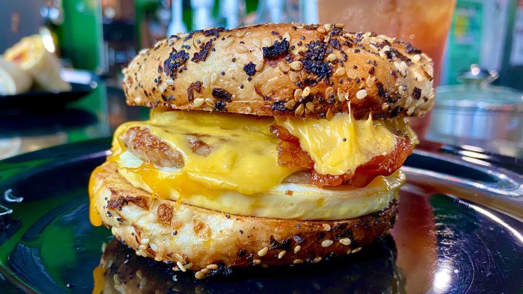 The W.I.H. · An everything bagel with two eggs, two slices of American cheese, bacon, sausage, and bourbon maple balsamic dressing
