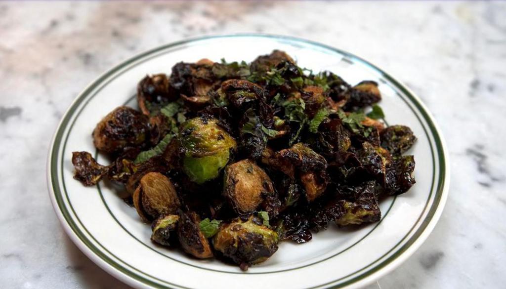 Brussel Sprouts · Deep fried Brussels sprout with scallions, chopped mint and tossed in a lemon vinaigrette. - Gluten Free
