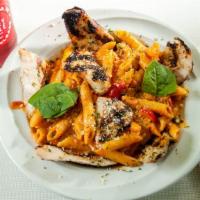 Penne Alla Vodka · Penne pasta with green peas, cherry tomatoes and grilled chicken in a rose cream sauce with ...