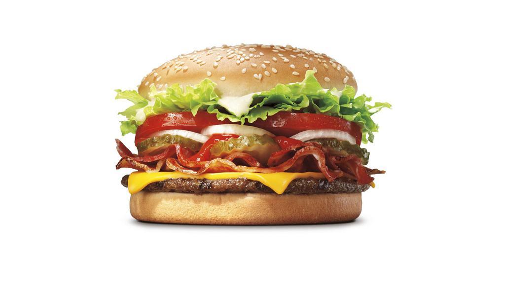 Whopper® With Bacon & Cheese · Our WHOPPER® Sandwich is a 1/4 lb* of savory flame-­grilled beef topped with smoked bacon, cheese, tomatoes, fresh lettuce, creamy mayonnaise, ketchup, pickles, and sliced onions on a soft sesame seed bun. *Based on pre-­cooked patty weight.