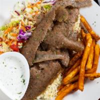 Gyro Kebab · Marinated lamb and beef mixed together, cooked on a vertical grill. Meat is shaved off and s...