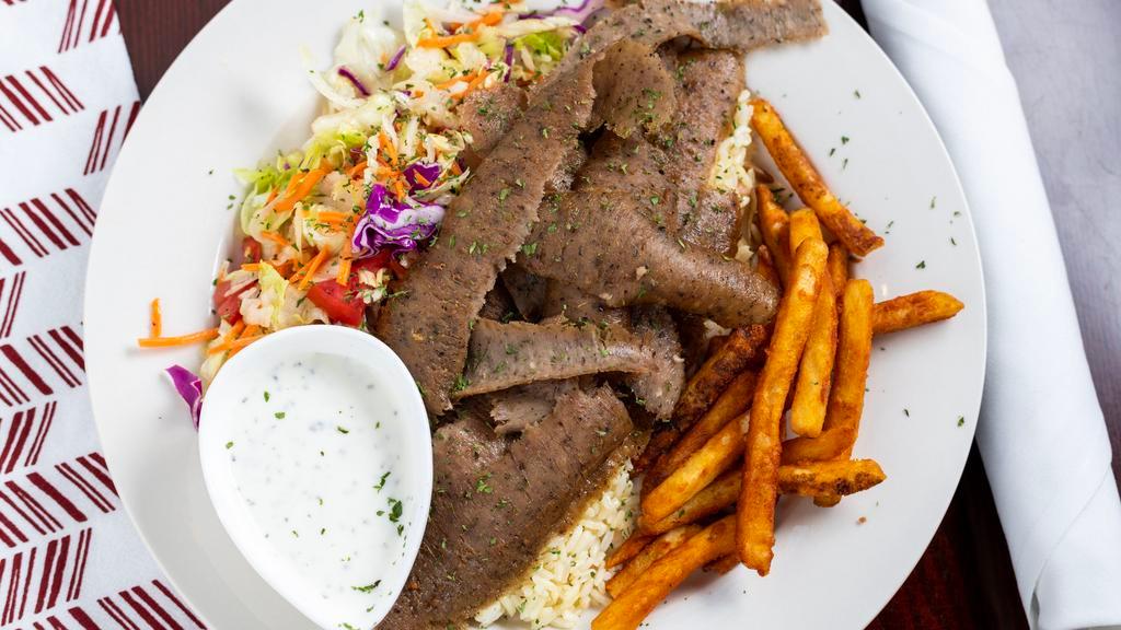 Gyro Kebab · Marinated lamb and beef mixed together, cooked on a vertical grill. Meat is shaved off and served as thin slices. Served with rice, fries and salad.