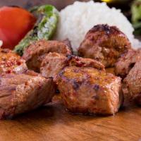Lamb Shish Kebab · Gluten-free. Marinated cubes of lamb grilled on skewers served with rice and salad.