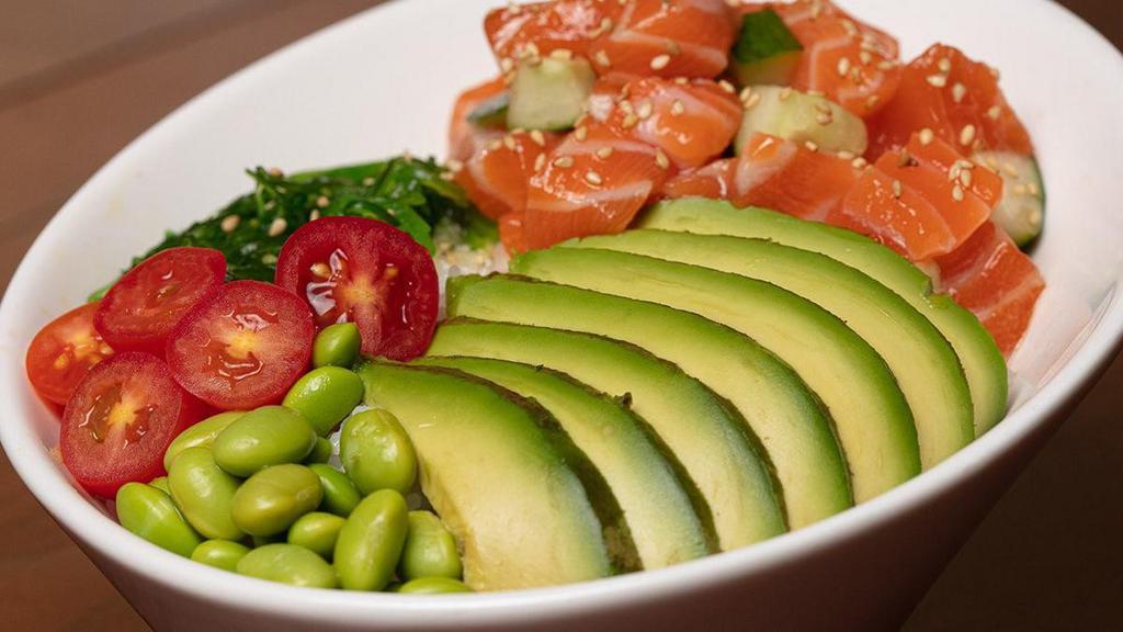 Salmon Poke Bowl · Salmon served with cucumber and green onions mixed. in poke sauce. Enhanced with grape tomatoes, avocados, edamame and seaweed salad; topped with sesame seeds .