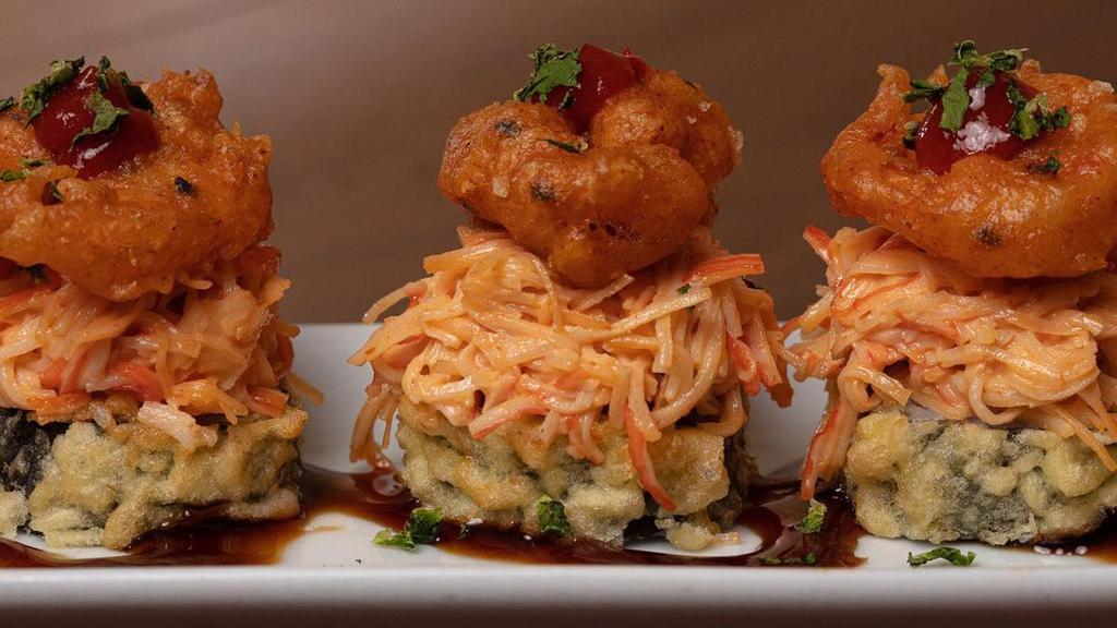 Chili Shrimp Roll · Krab† and cream cheese rolled and lightly tempura battered, topped with spicy krab† mix, crispy shrimp. and cilantro; served with Sriracha and sweet eel sauce.