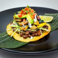 Tostada · Contains nuts. Corn tostada, miso mole black beans, red cabbage, charred zucchini and eggpla...