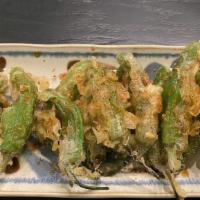 Blistered Shishito Peppers · Beer battered tempura peppers, sea salt, orange zest, w/sauce