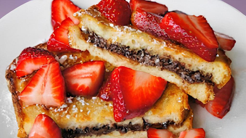 Nutella Stuffed French Toast (3 Slices) · 3 slices french toast stuffed with nutella and topped with sliced strawberries