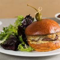 Burger Au Poivre · Grass-fed beef burger with caramelized onions, Comté cheese and au poivre aioli on a brioche...