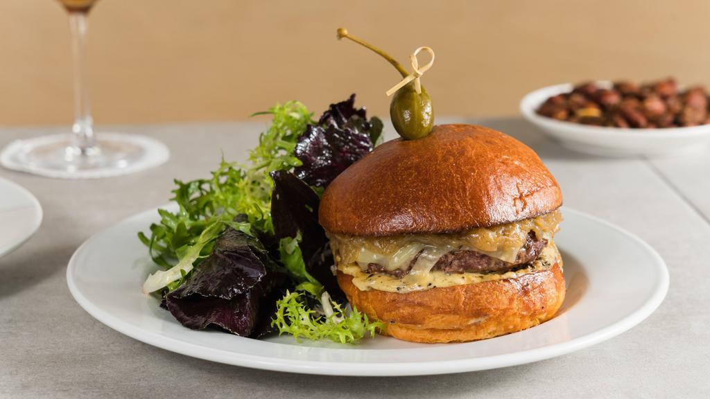 Burger Au Poivre · Grass-fed beef burger with caramelized onions, Comté cheese and au poivre aioli on a brioche bun. Served with a market salad.