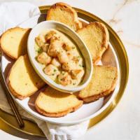 New! Bay Scallop Scampi · Tender bay scallops in garlic, white wine
and our lemon butter sauce, served with
baked bread