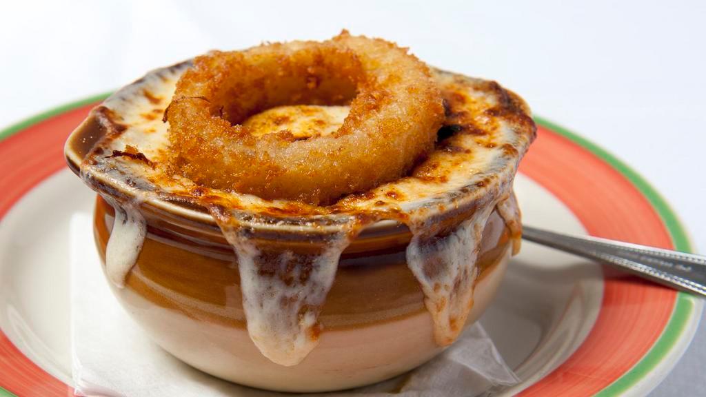 French Onion · Crock of French onion soup topped with an onion ring.