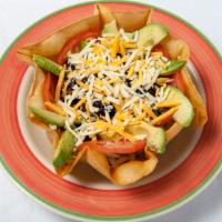 Taco Salad · Served in taco bowl! Ground beef, lettuce, three cheese, avocado, black beans, corn, tomatoe...