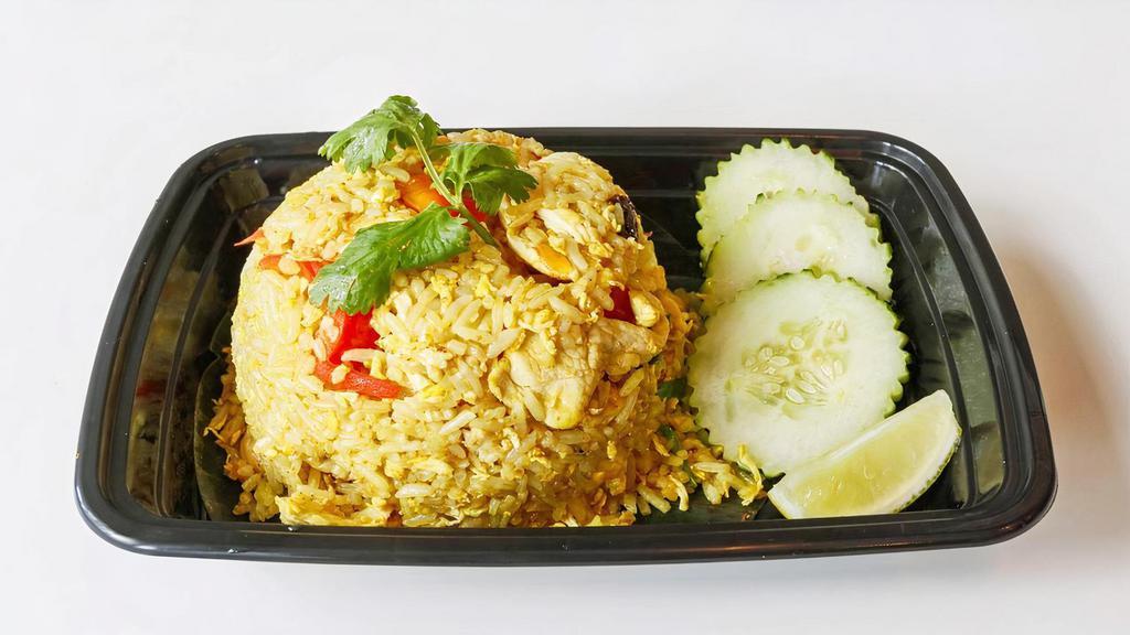 Pineapple Fried Rice · Stir-fried rice, pineapple, bell pepper, raisin, cashew nut, fried egg, and curry powder.