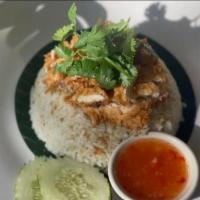 Kao Mun Gai Tod · Spicy. Crispy homemade fried chicken over chicken stock rice with ginger sauce and sweet chi...
