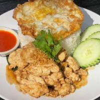 Kao Gai Ka Taim · Sauteed sliced chicken breast with garlic sauce and fried egg  over jasmine rice and Srirach...