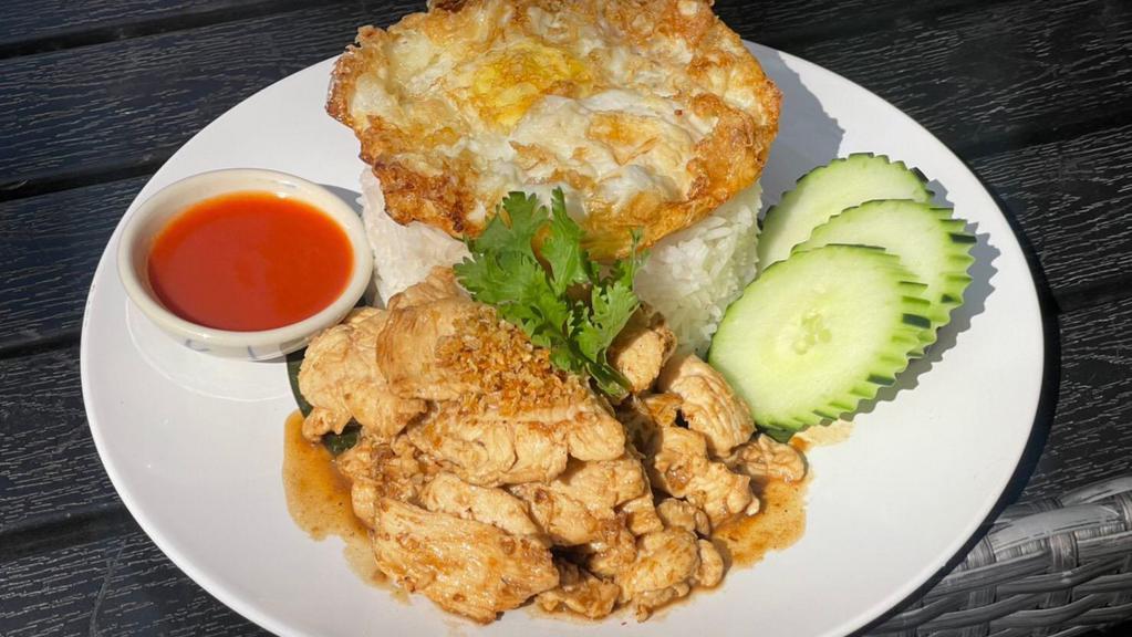 Kao Gai Ka Taim · Sauteed sliced chicken breast with garlic sauce and fried egg  over jasmine rice and Sriracha sauce on the side.
