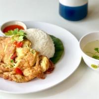 Kao Kai Jieow · Thai style vegetables (onions, scallions) omelet and over jasmine rice and sriracha sauce on...