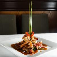 Koong Makham · Grilled shrimp, spinach, delectable tamarind sauce, red onion.