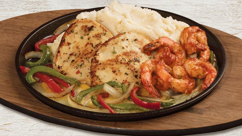 Sizzling Chicken & Shrimp · Garlic-marinated chicken breasts with shrimp tossed in marinara. Served over melted cheese with onions, red and green bell peppers, and mashed potatoes. 1310 cal.