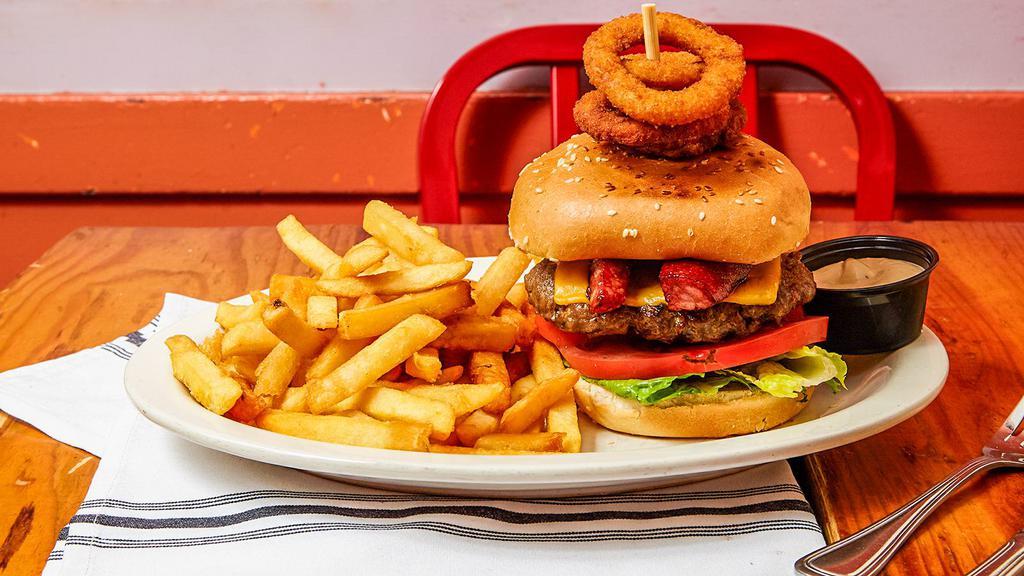 10 Oz. The Fiesta Burger · Burger loaded with onion rings and chorizo, lettuce and tomato. Served with French fries.