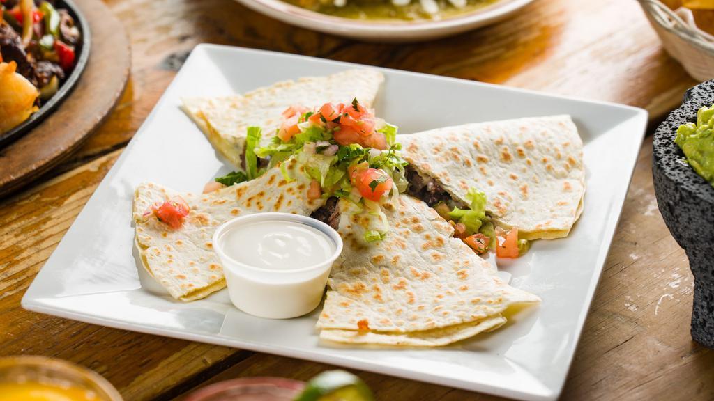 Grilled Steak Quesadilla · Served with rice and beans garnished with pico de gallo, crema and queso fresco.