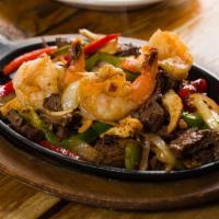 Supreme Fajitas · Combo of chicken, steak and shrimp. Choice of tortilla with sauteed poblano peppers, bell pe...