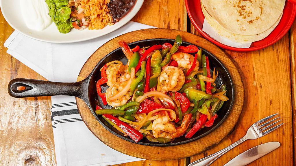 Shrimp Fajitas · Choice of tortilla with sauteed poblano peppers, bell peppers, onions and roasted tomato sauce with guacamole, crema fresca, pico de gallo, rice and beans.