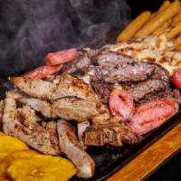 Parrillada De Carne · Grilled Meat Platter: Churrasco, Pechuga de Pollo, Chuleta, Chorizo con Tostones & Yuca Frita