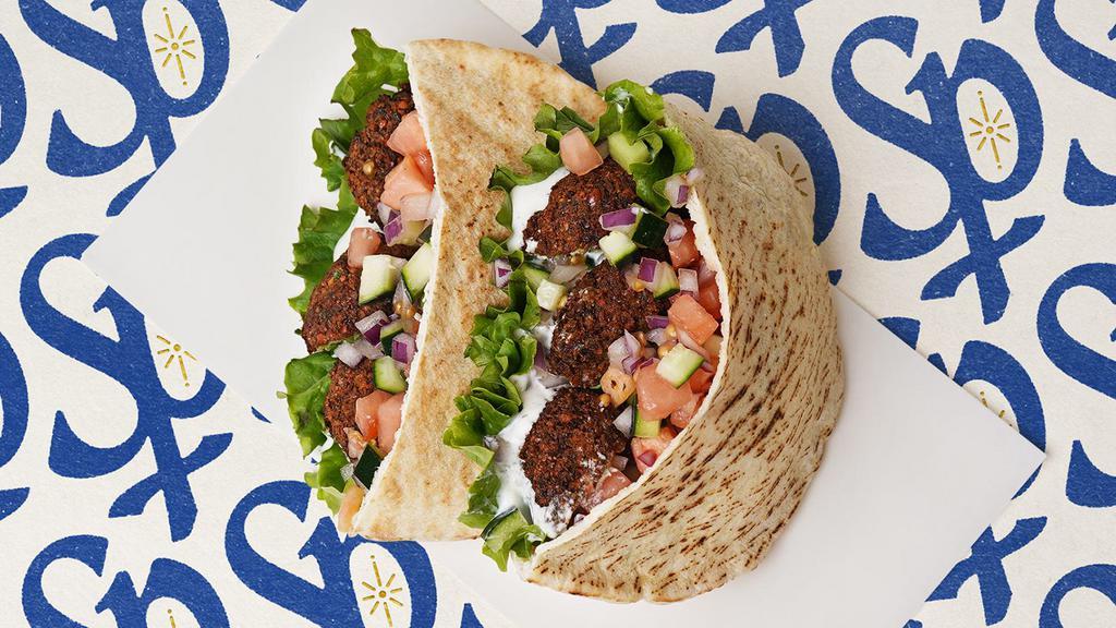 Falafel Pita Sandwich Pita · Falafel pieces with lettuce, tomatoes, cucumber, onions, and your choice of sauce wrapped in a pita