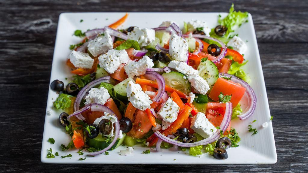 Greek Salad · Tomatoes cucumbers onions olives and feta cheese in an olive oil dressing.