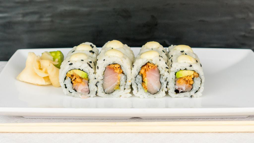 Hella Yella · Yellowtail, avocado, onion crunchies, and a touch of fresh lemon topped with chef sauce.