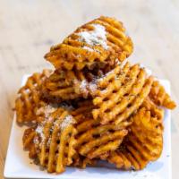 Parmesan Truffle Fries · Waffle fries topped with premium truffle oil, fresh Parmesan or vegan Parmesan for an additi...