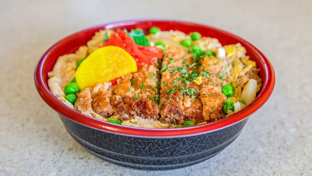 Chicken Katsu Don · Bowl of rice topped with deep fried chicken cutlet simmered in dashi based broth with onions, green peas and eggs.