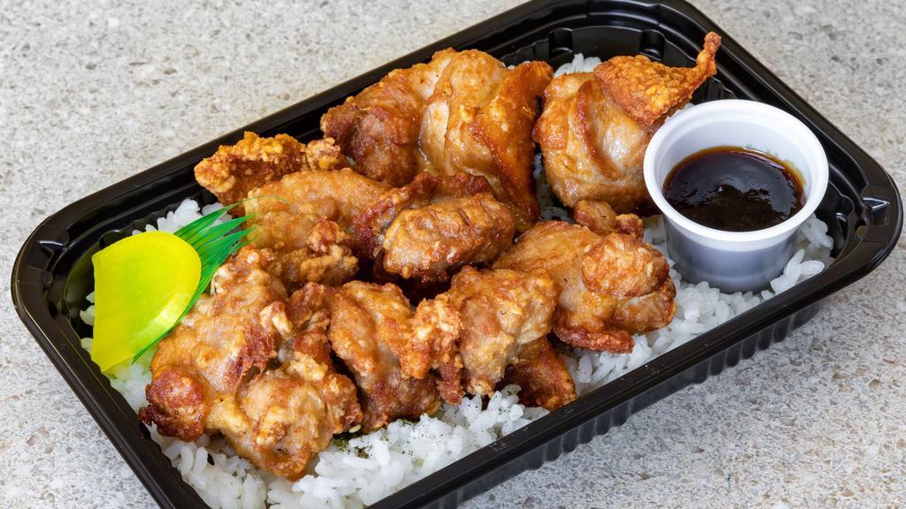 Mochiko Chicken Bento · Mochiko chicken on a bed of furikake rice or tossed salad. Comes with house made BBQ (Japanese style)  sauce in a container.