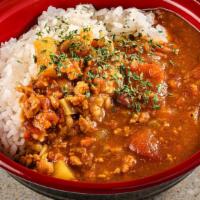 Curry Rice Bowl · House made curry with white rice in a bowl.  Tomato based curry has chicken mince and vegeta...
