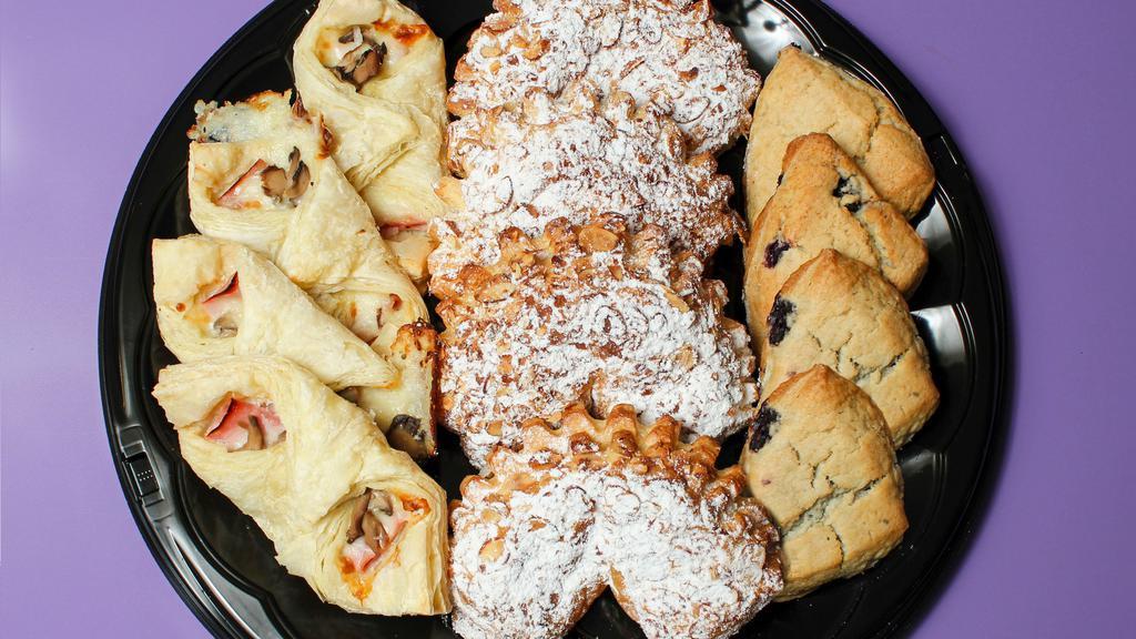 Pastries · Ham cheese and mushrooms in a puff pastry, almond filled bear claws and blueberry scones.