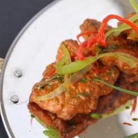 Fish Apollo · Fillets of fish marinated in a spiced batter, deep fried and tossed in curry leaves.