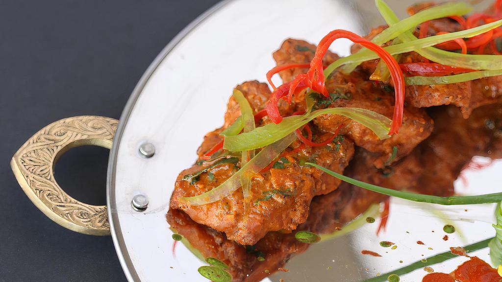 Fish Apollo · Fillets of fish marinated in a spiced batter, deep fried and tossed in curry leaves.