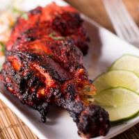 Tandoori Chicken · An all time favorite, tender leg quarters, marinated in yogurt and a mild blend of ginger, g...
