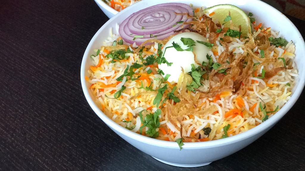 Goat Dum Biryani · Our signature dish - fragrant basmati rice layered and slow cooked with choicest cuts of goat meat. Marinated in yogurt, fried onions and a variety of fresh herbs and spices.