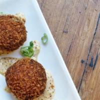 Boudin Balls · Cajun fried rice sausage balls served with house-made remoulade sauce and squash pickles.
