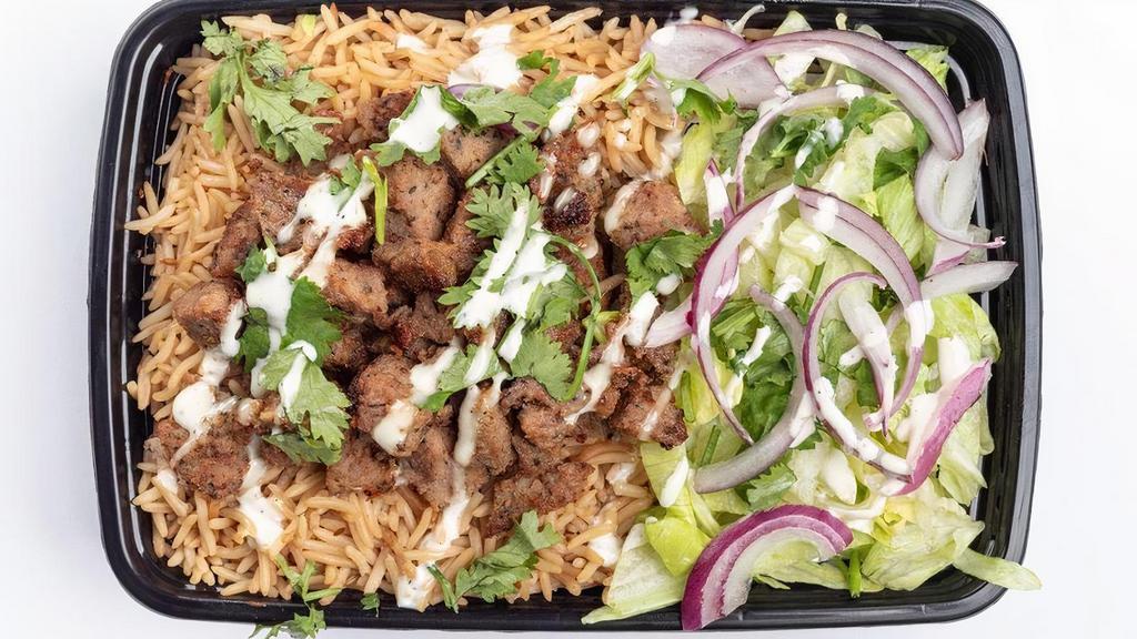 Lamb Over Rice · Grilled lamb, with Afghani style basmati rice, cilantro, onions, optional sauce, and salad (lettuce &. red cabbage only).