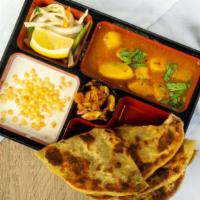 Aloo Pyaaj Paratha · Spiced mashed potatoes and chickpeas stuffed in a flatbread served with homestyle potato cur...